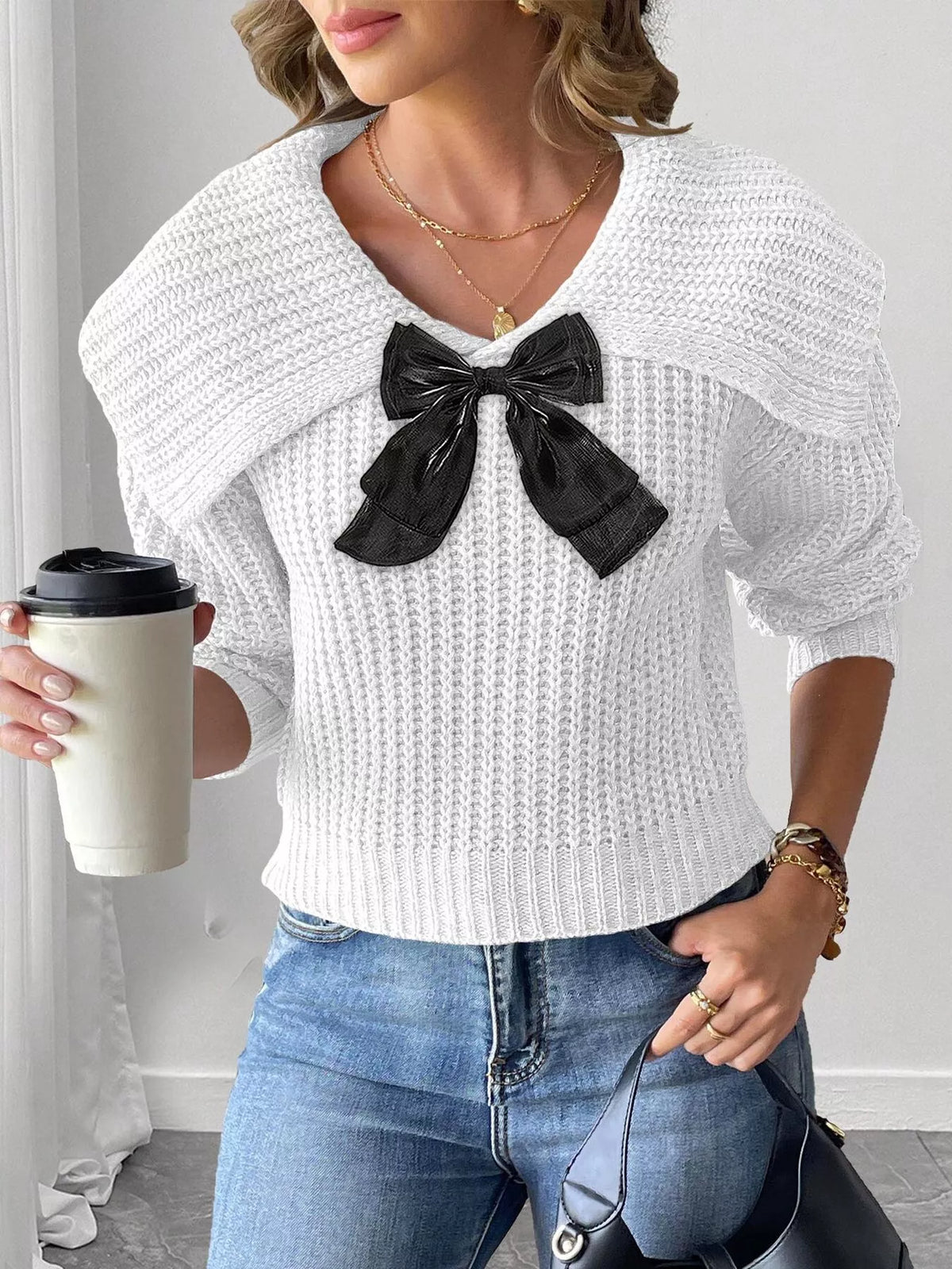 Contrast bow long sleeve sweater paired with skirts, showcasing stylish knitwear from Trendsi with a focus on the detailed bow design.