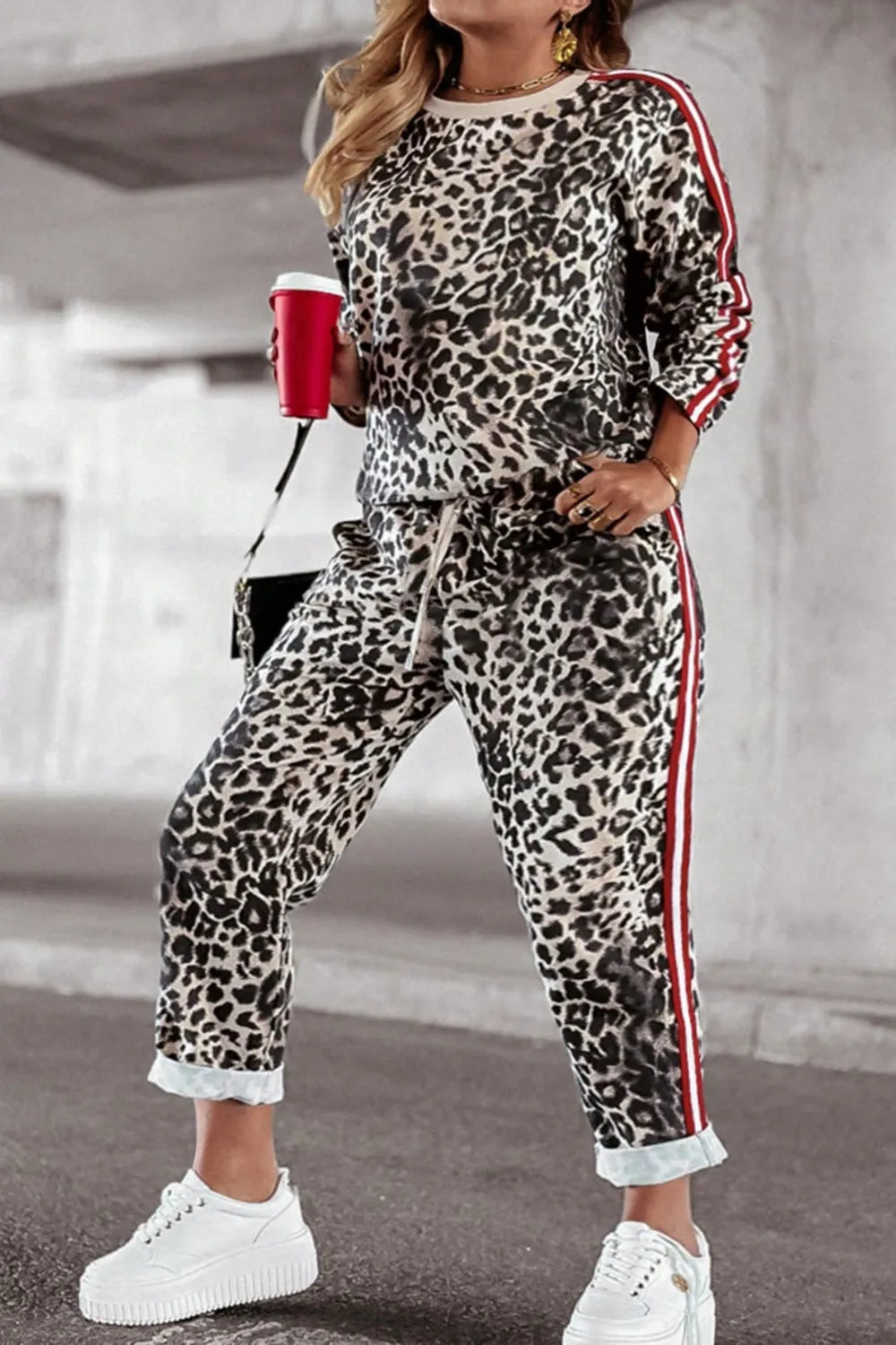 Plus size leopard print round neck top and pants set by Trendsi, featuring a stylish and comfortable matching outfit.