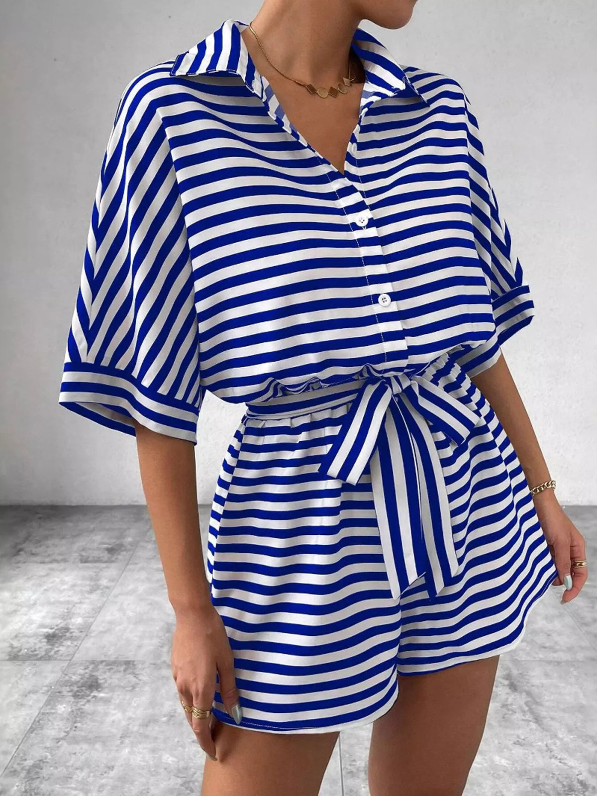Striped button-front half sleeve romper shirt by Plush Fashion Hub, featuring a casual, stylish design with a front button closure.