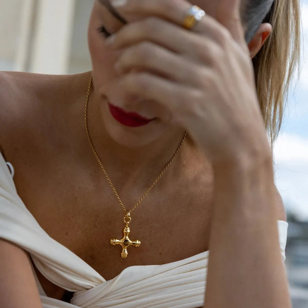 Gold-plated stainless steel cross pendant necklace with a sleek design, perfect for stylish accessories.