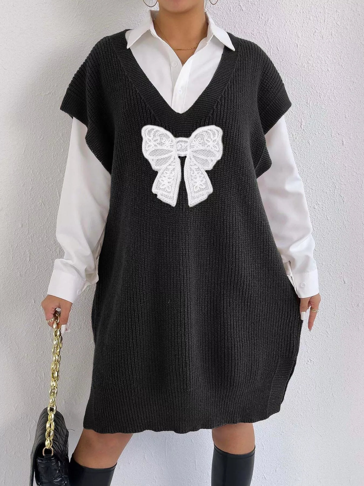 Embroidered bow V-neck sweater vest by Trendsi, featuring intricate embroidery and a classic V-neck design, styled for layering.