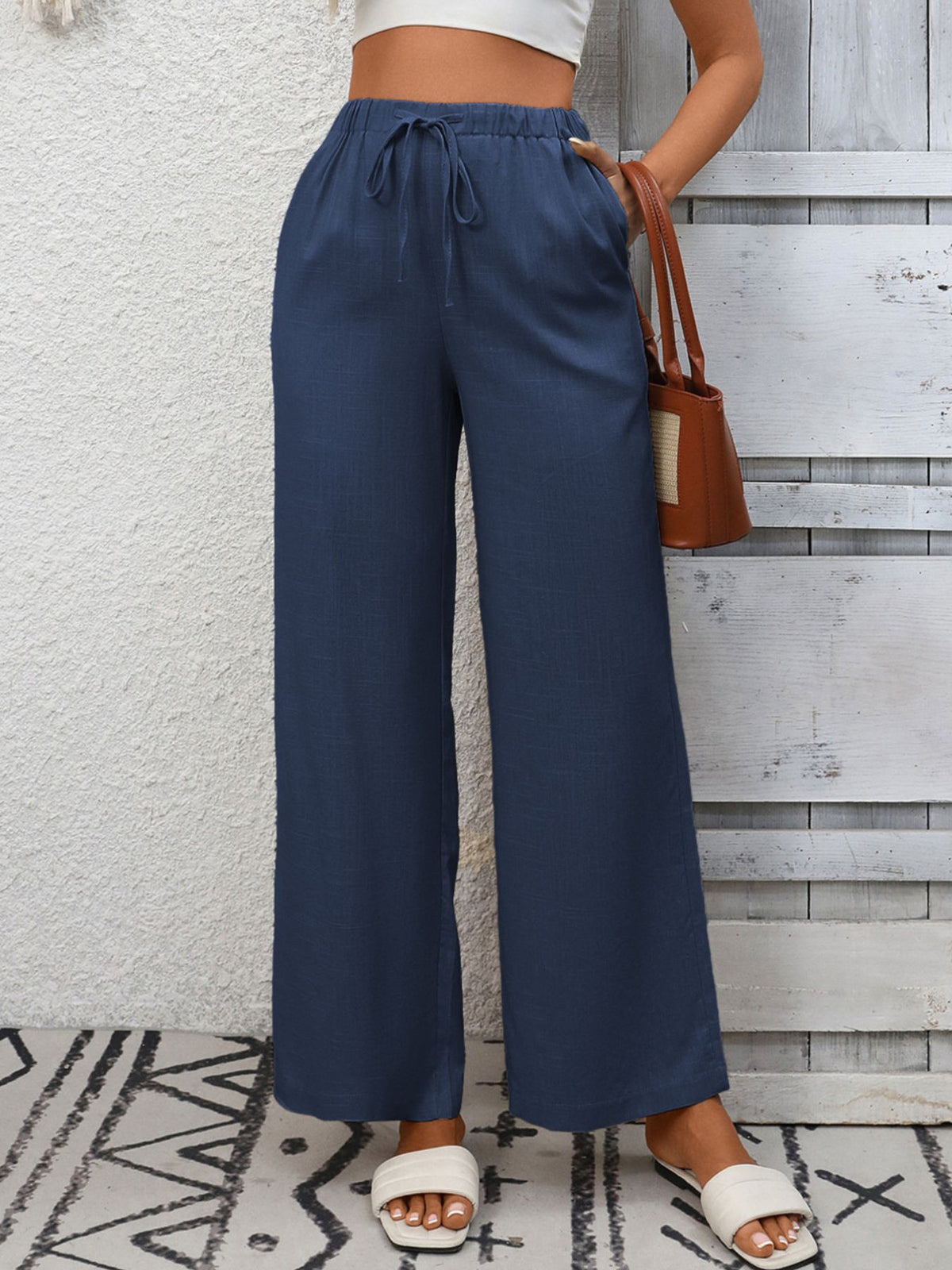 Women's high-waisted wide-leg drawstring pants in soft, breathable viscose fabric, shown in a relaxed fit with a drawstring waist.