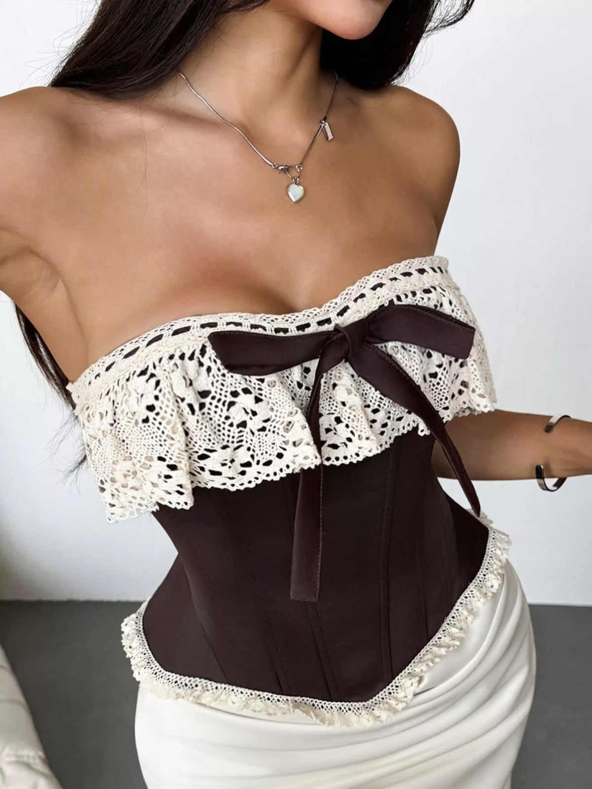 Crochet lace strapless corset with boning and lace-up front, designed as a waist cincher and tube top for a fitted silhouette.