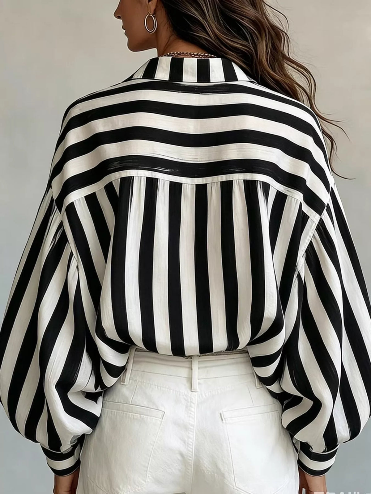 Women’s striped loose fit shirt by Trendsi, featuring a casual design with horizontal stripes and a relaxed fit.