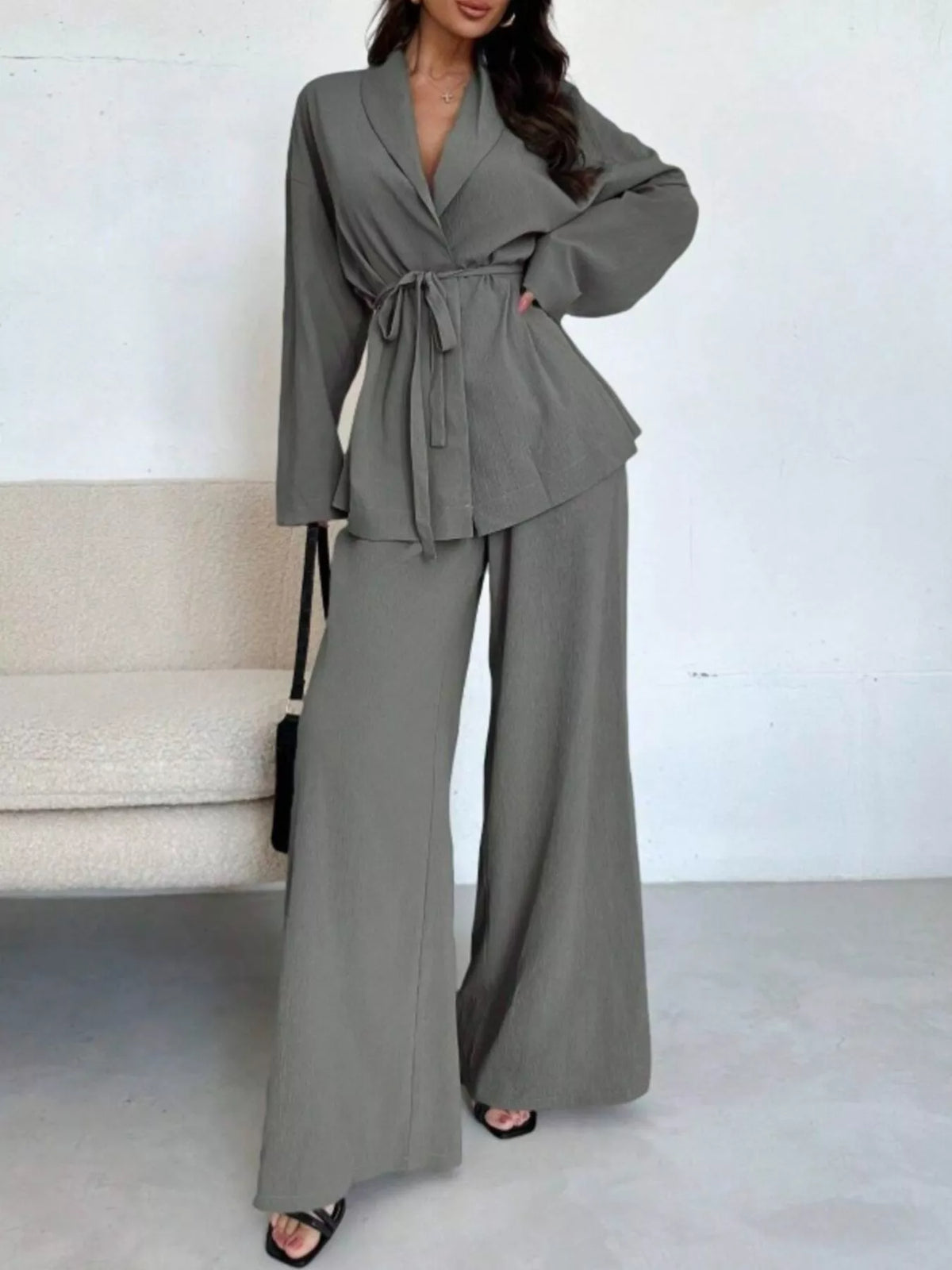 Textured tie waist top and wide-leg pants set for women by Trendsi, featuring a stylish matching two-piece outfit.