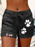 Women's printed elastic waist cropped shorts with pockets, casualwear from Plush Fashion Hub, shown in navy with floral pattern.