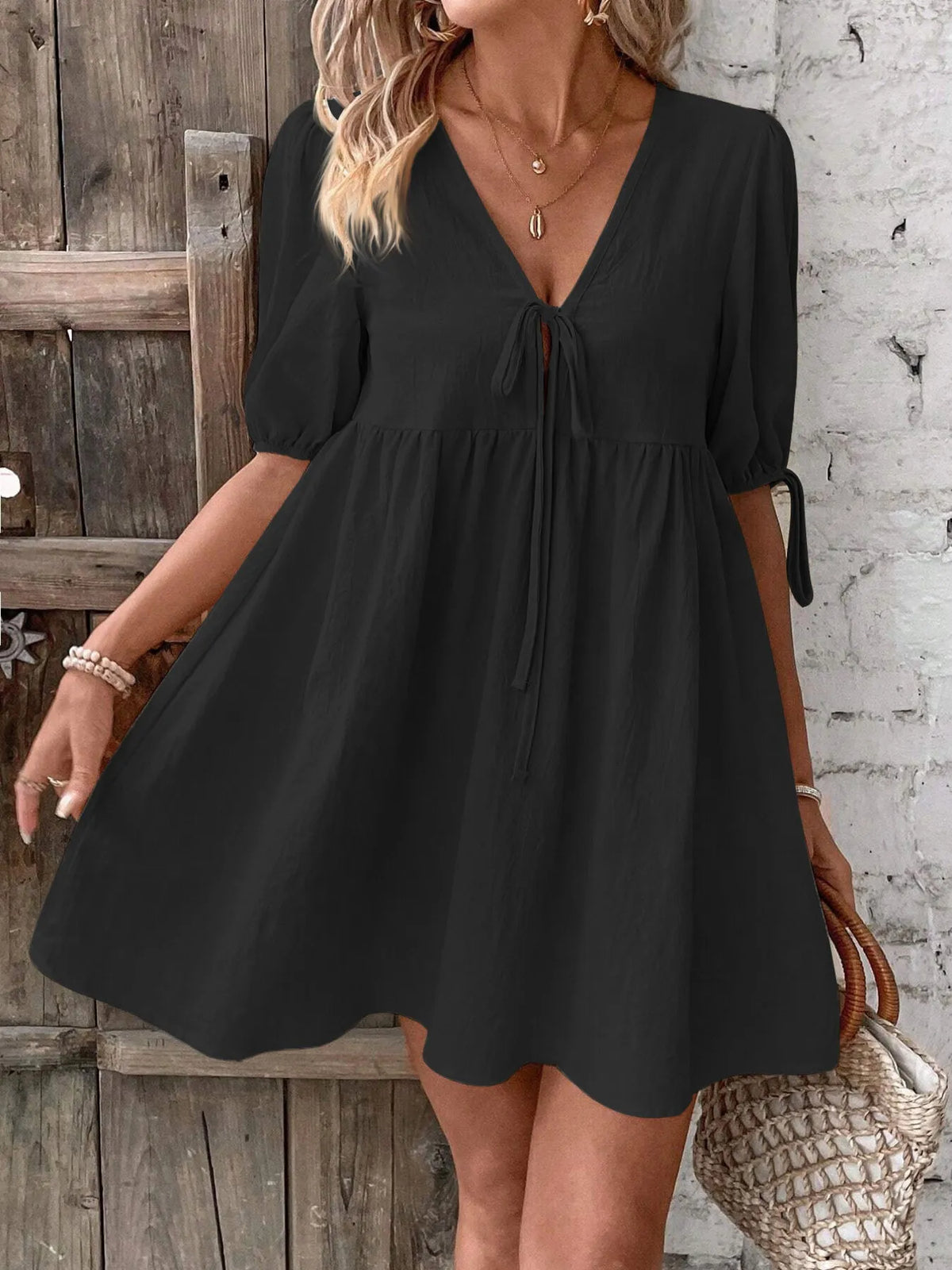 Cotton V-neck tie-front mini dress with puff sleeves by Plush Fashion Hub, showcasing the fitted silhouette and stylish design.