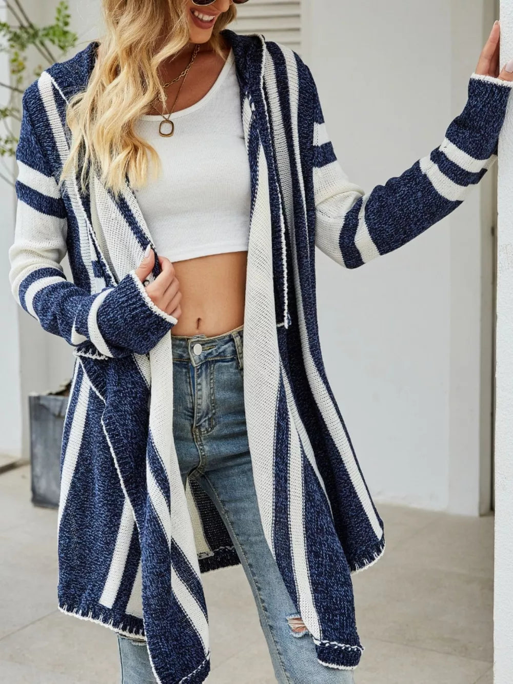 Striped hooded open front cardigan by Trendsi, featuring a cozy knitted design with bold stripe patterns and a relaxed fit.