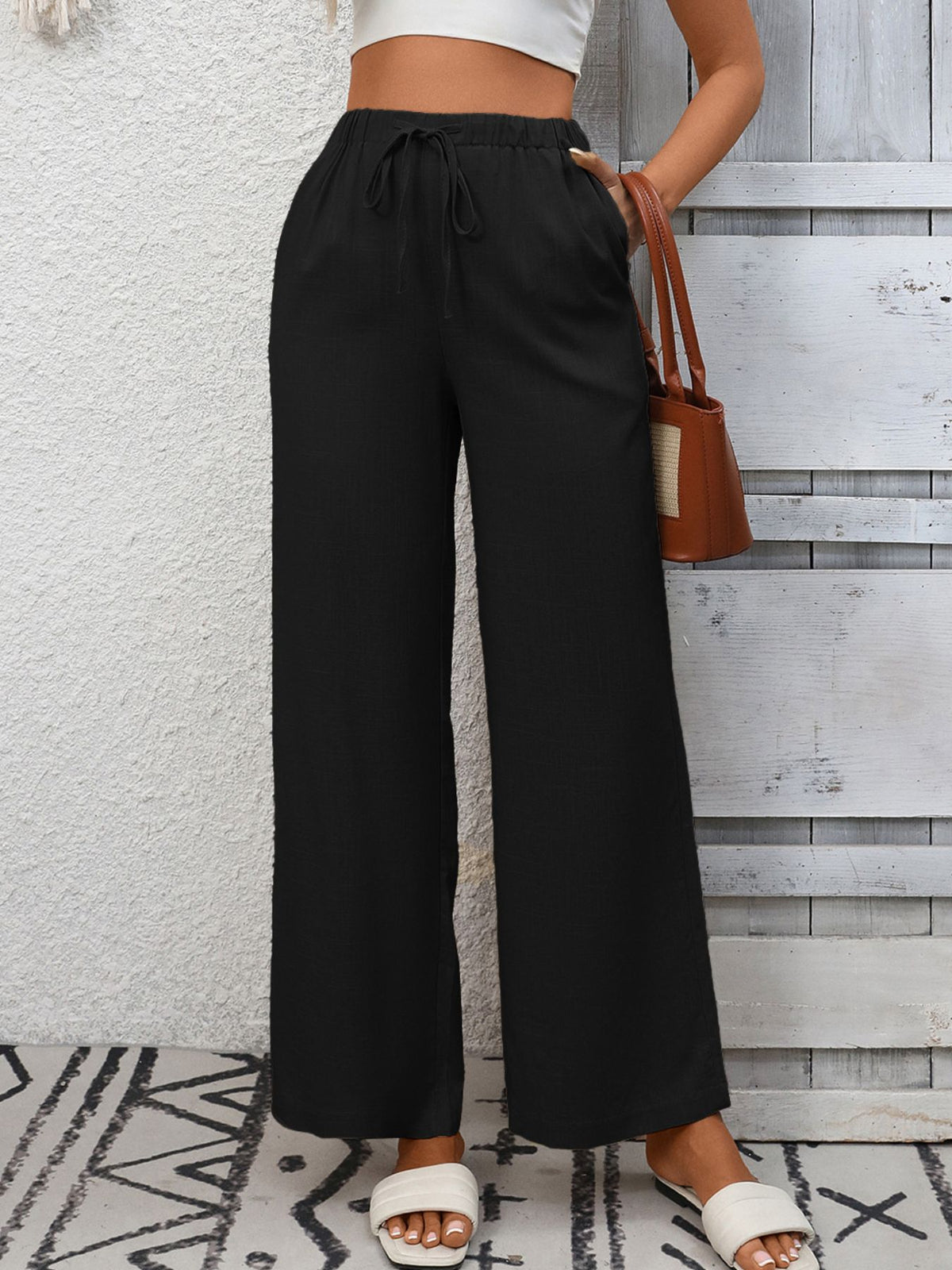 Women's high-waisted wide leg drawstring pants in soft breathable viscose, shown with a relaxed fit and comfortable waistband.