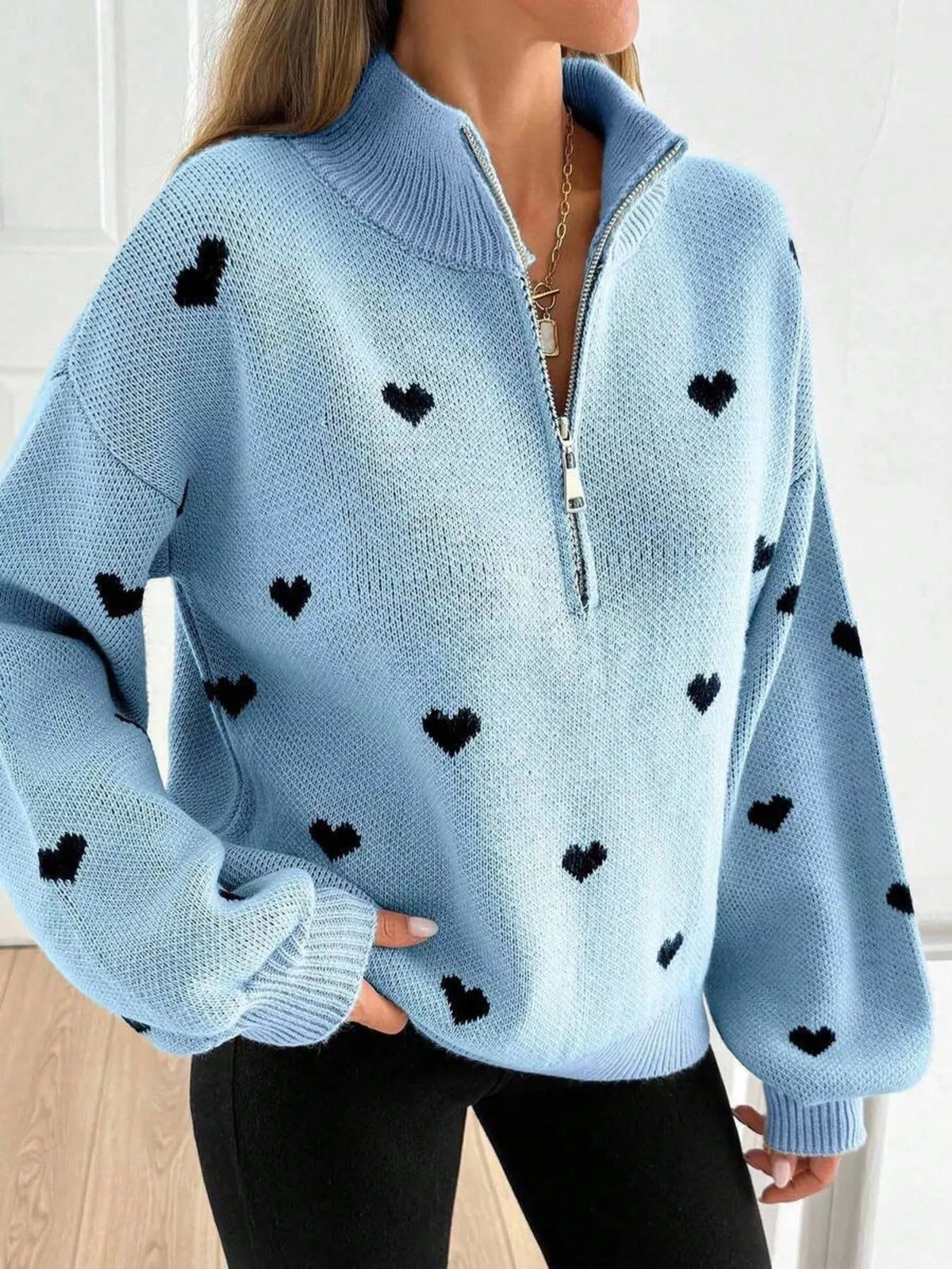 Plus size full heart half-zip long sleeve sweater by Trendsi, featuring a cozy design with a heart pattern and comfortable fit.