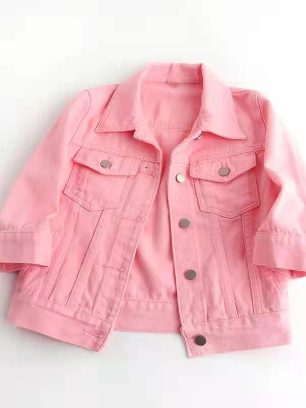 Plus size full-length cropped denim jacket from Trendsi, showcasing classic blue denim with front pockets and button closure.