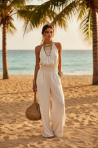 Women's black halter-neck backless wide-leg jumpsuit by Plush Fashion Hub, featuring a sleek solid color street style design.