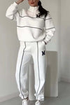 Women's white pullover sweatsuit set with stripes and pockets, featuring a stylish sporty design for comfy lounge wear.