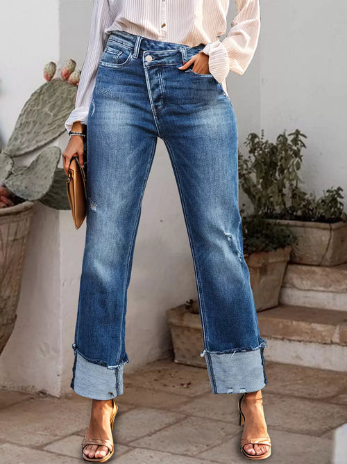 Light-wash denim jeans with stepped waist, raw hem, and rolled straight fit from Trendsi, showcasing detailed front view.