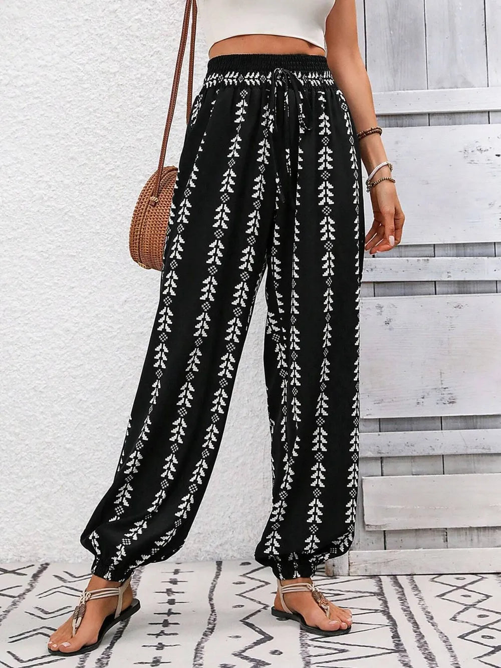 Printed high-waist pants from Trendsi featuring a tied front design and a relaxed fit, styled with a casual top.