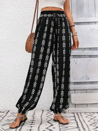 Printed high-waist pants from Trendsi featuring a tied front design and a relaxed fit, styled with a casual top.