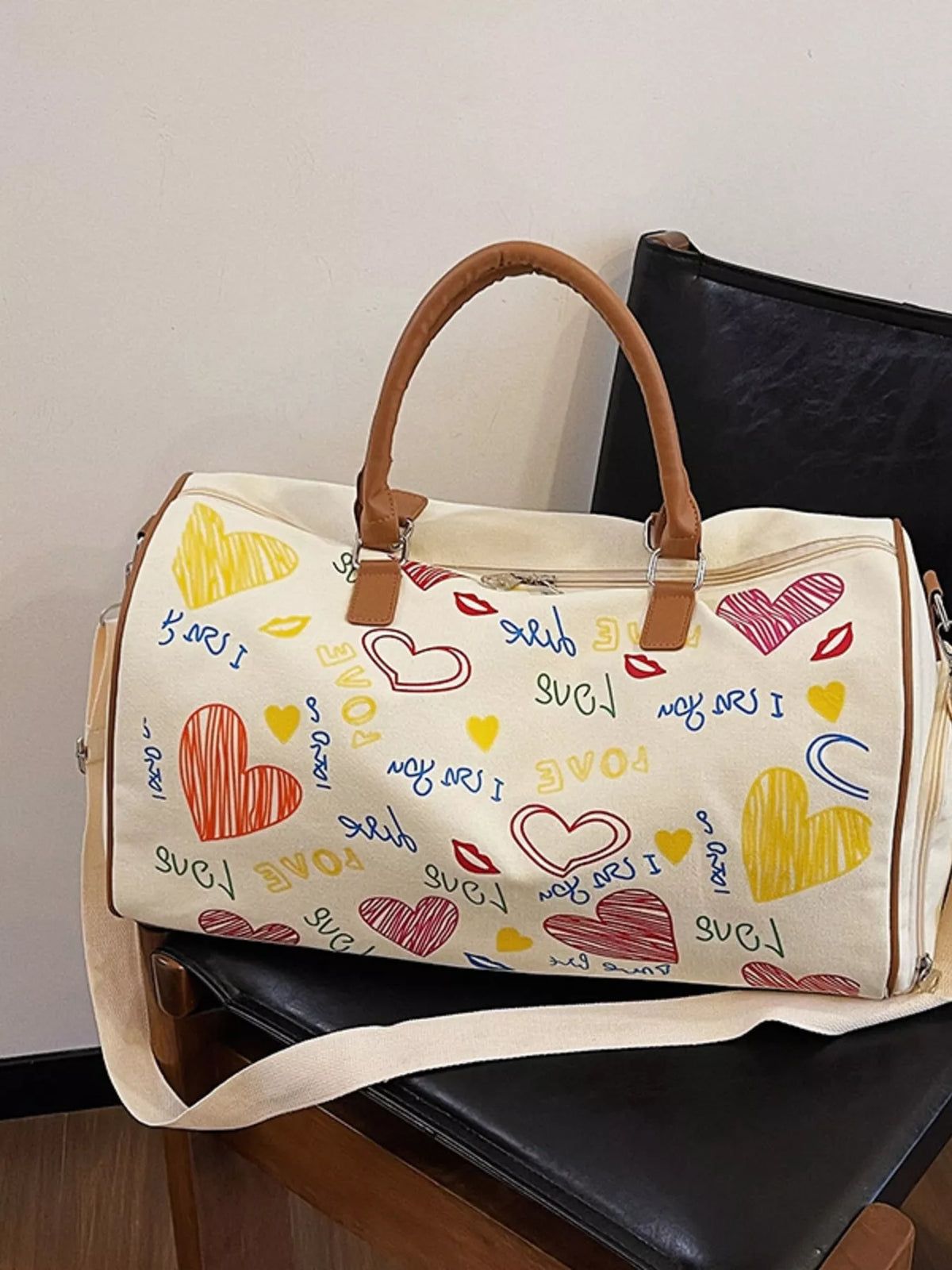 Printed Plush Fashion Hub duffel bag with adjustable strap, showing a spacious bag with colorful printed design and sturdy handles.