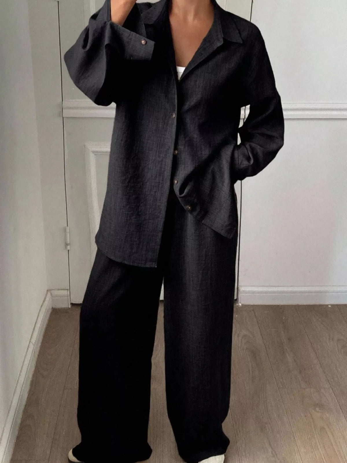Trendsi long sleeve button-up shirt and wide-leg pants set, stylish and comfortable, shown laid out flat with neutral background.