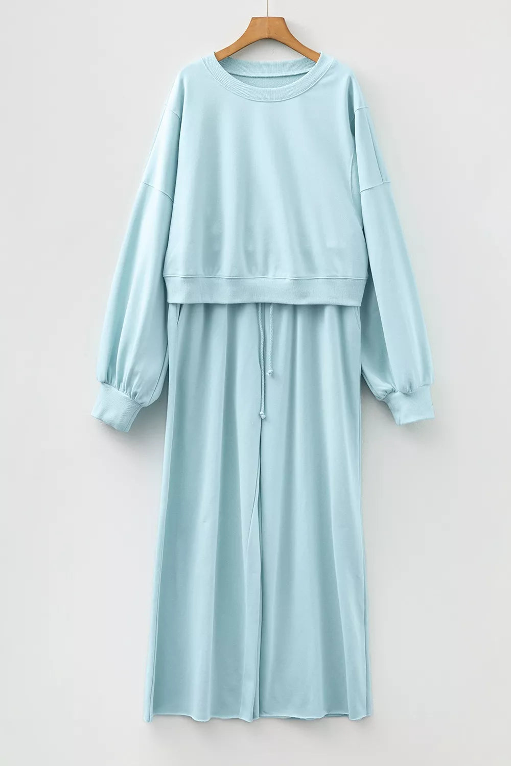 Drop shoulder puff sleeve crop pullover and wide-leg pants set by Trendsi, featuring a stylish, coordinated outfit in soft fabric.