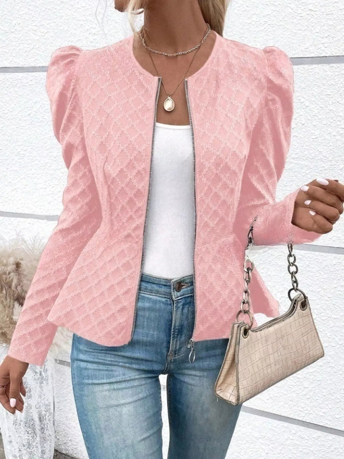 Women’s textured jacquard jacket with puff sleeves, stylish and fashionable, featuring a fitted design in a close-up view.