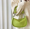 Female high-end retro diagonal handbag in green with unique belt decoration and spacious interior.