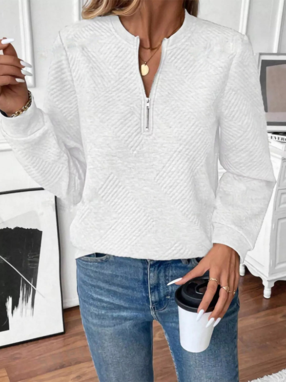 Textured women's quarter-zip sweatshirt by Trendsi, showing close-up of fabric and quarter-zip detail in a neutral color.