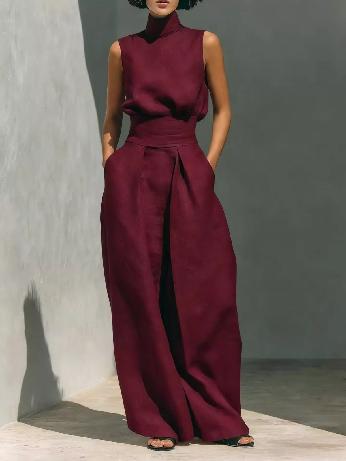 Plus size full length sleeveless jumpsuit with wide-leg design and smocked waist by Trendsi, shown on a model.