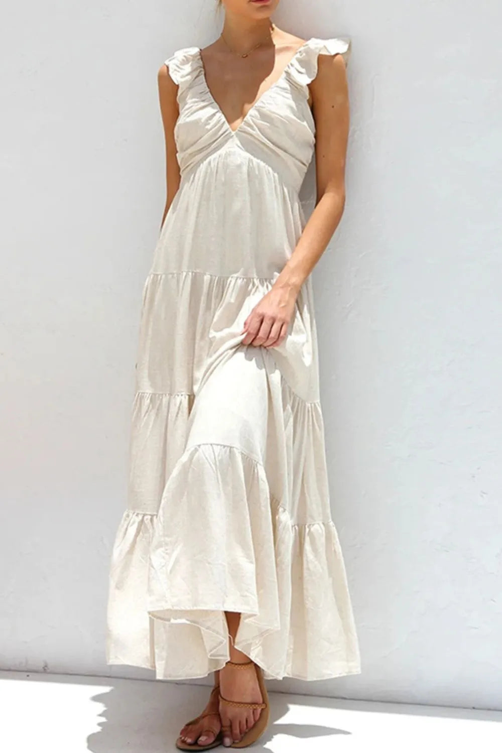 Women's 100% cotton ruffled V-neck tiered midi dress with a flowy silhouette, featuring ruffle details and a V-neckline.