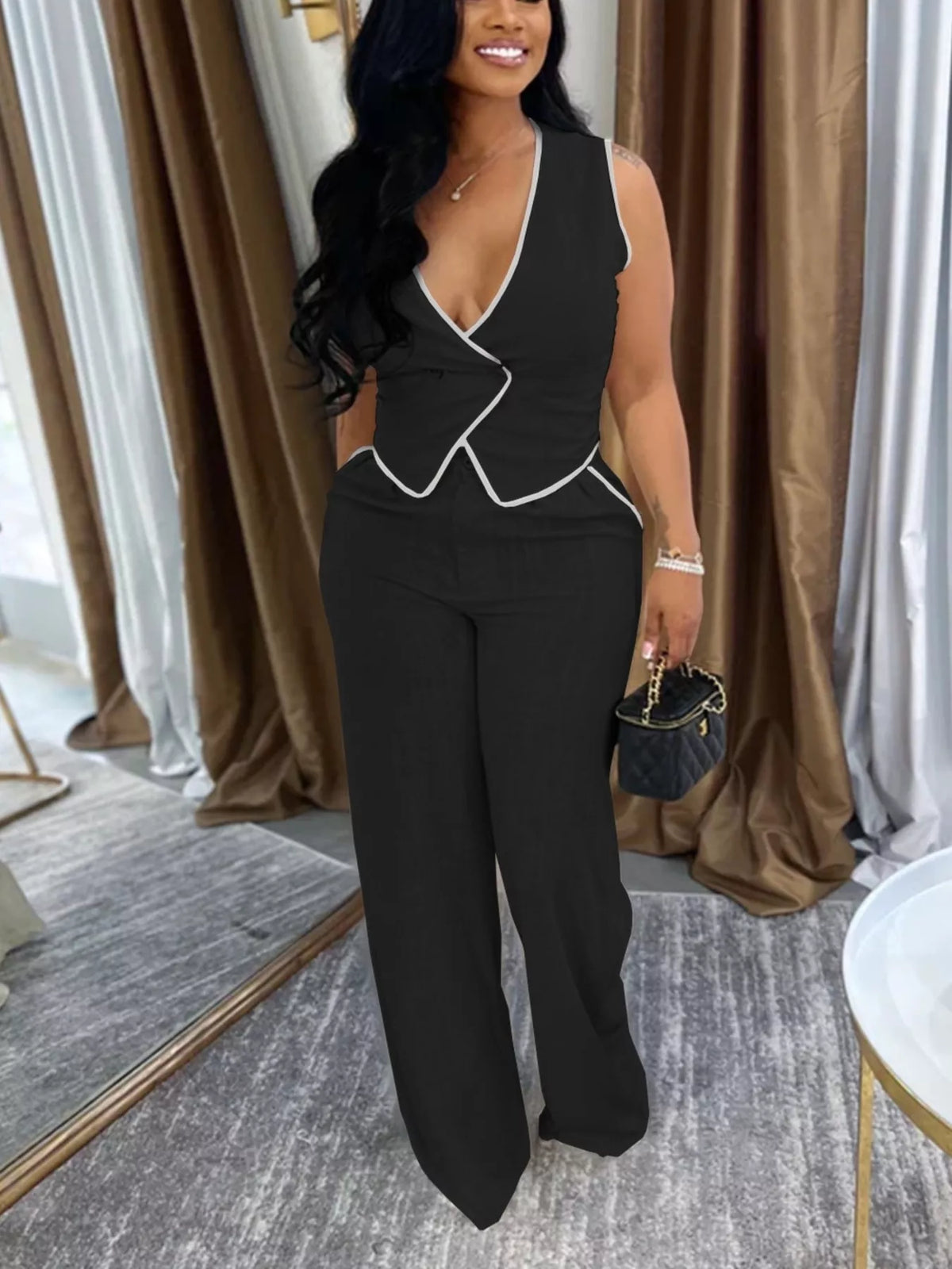 Contrast trim sweater vest and wide-leg pants two-piece set by Trendsi, featuring a stylish sweater and matching wide-leg pants.
