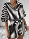 Striped button-up belted romper by Trendsi featuring vertical stripes, a collar, and a waist belt for a stylish summer look.