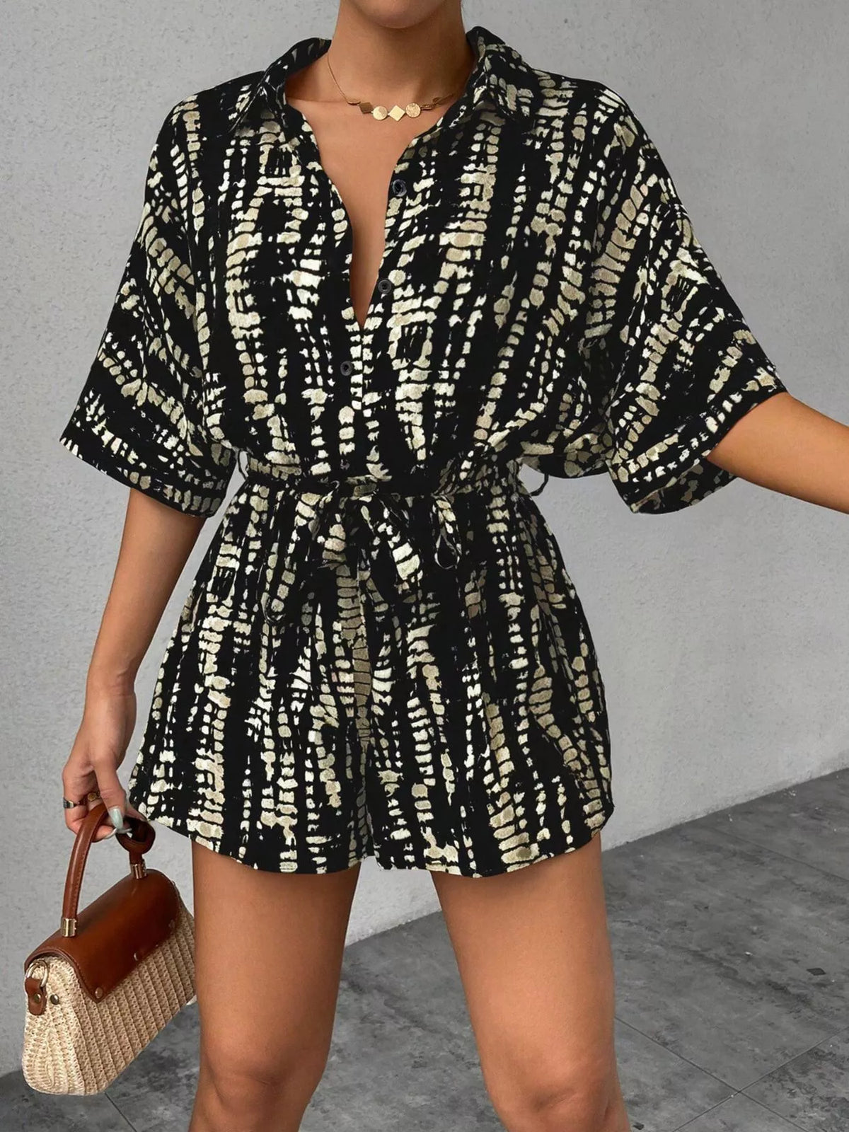 Striped button-up belted romper jumpsuit from Plush Fashion Hub, featuring a stylish design and comfortable fit.
