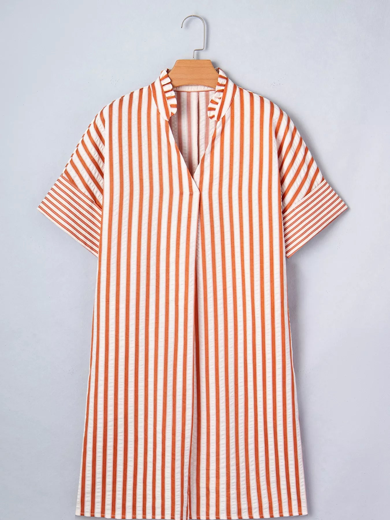Stripe pinched V-neck mini dress with turn-up cuffs and pockets, trendy dress by Trendsi, shown in the image.