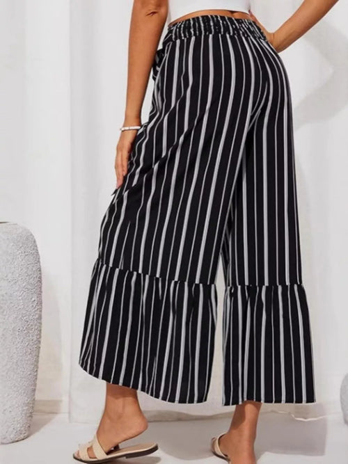 Plus size printed wide-leg pants with tie waist from Trendsi, featuring a full size and stylish relaxed fit.