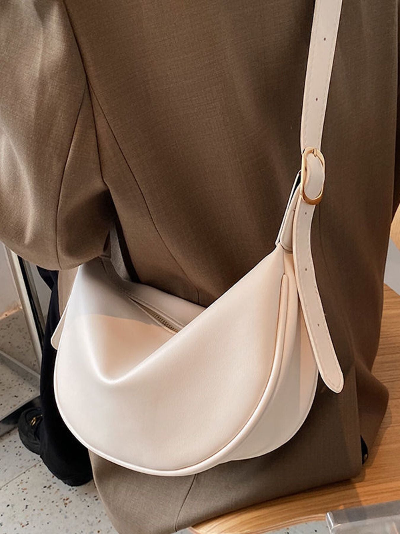 Minimalist crescent-shaped Trendsi crossbody bag with smooth PU leather shoulder purse, featuring a sleek, modern design.