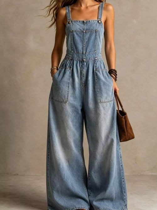 Full size wide leg denim jumpsuit with adjustable straps and pockets, stylish plus size Trendsi jumpsuit on a model.