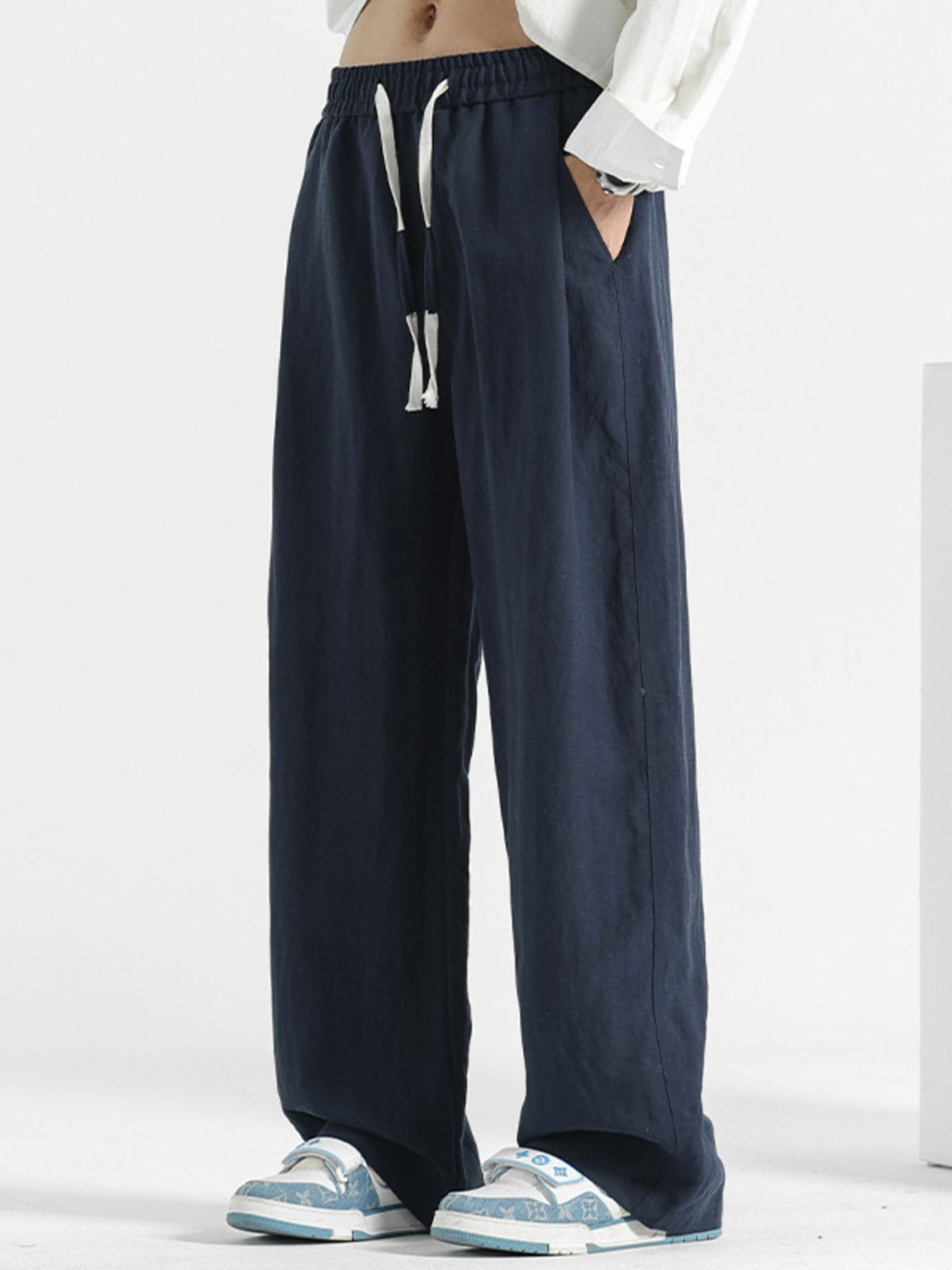 Men's casual loose fit pants with pockets, made by Plush Fashion Hub, featuring comfortable stretch fabric and relaxed style.