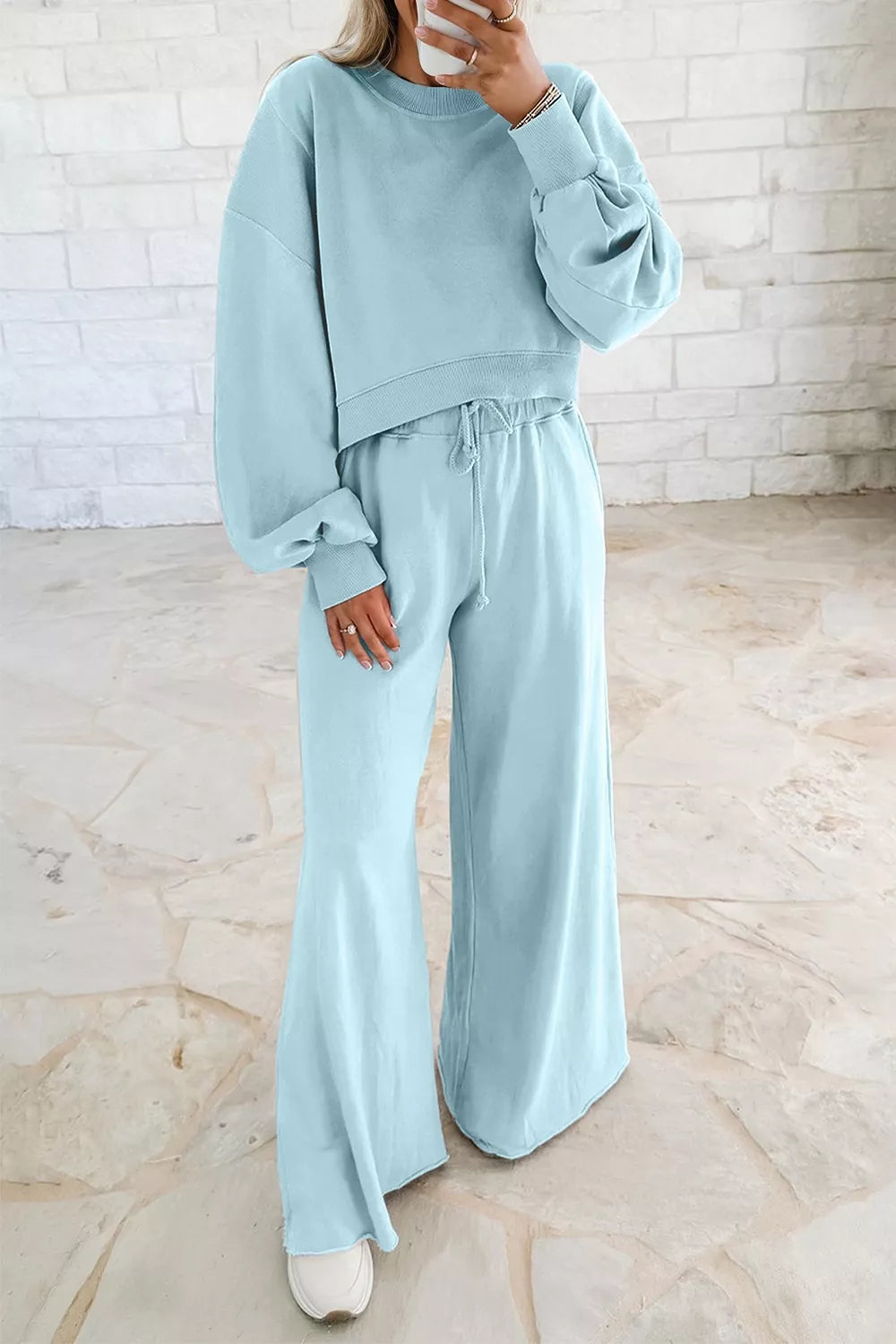 Drop shoulder puff sleeve crop pullover and wide-leg pants set by Trendsi, featuring a stylish, coordinated fashion look.