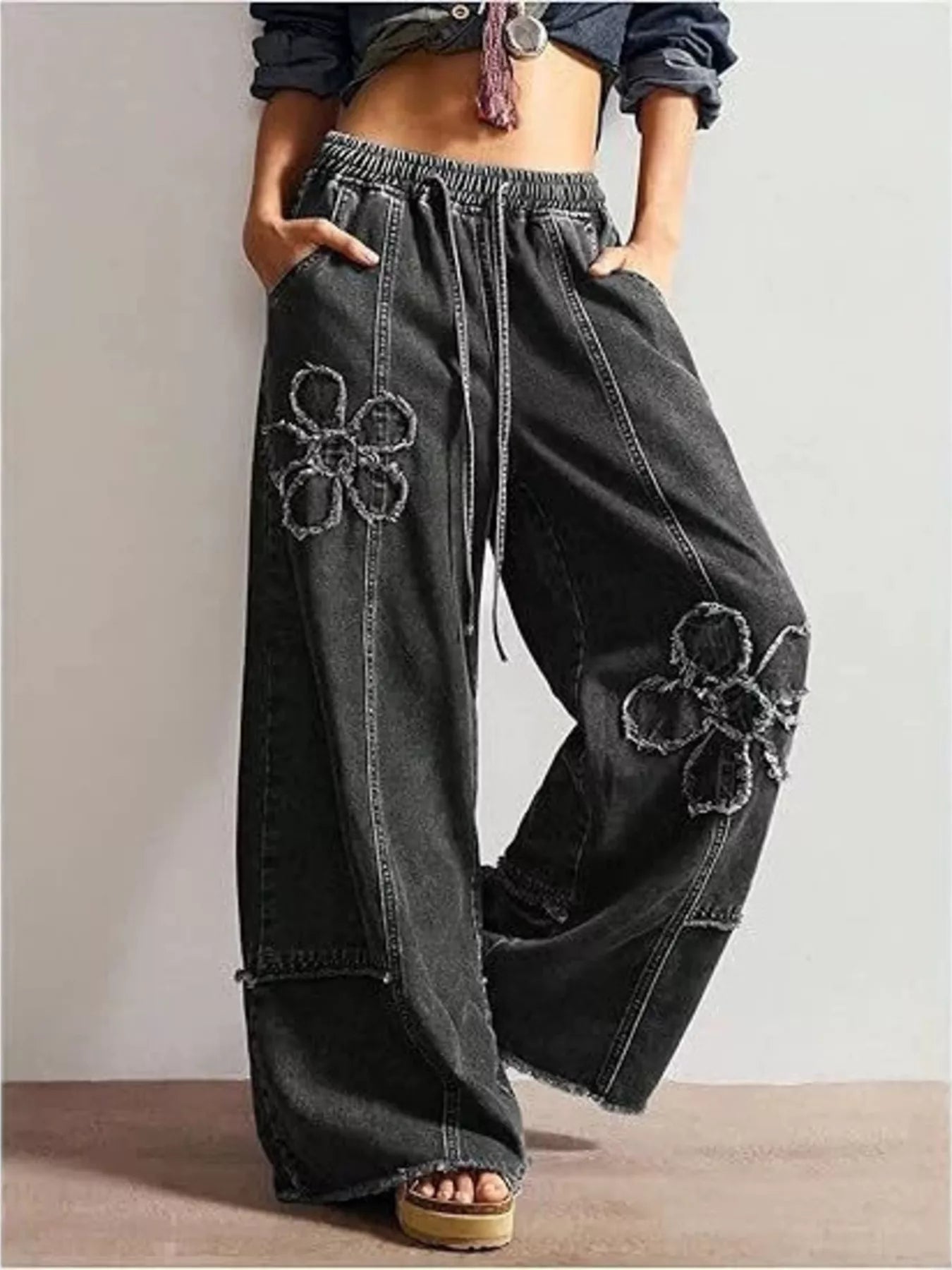 Wide leg jeans with floral appliqué details from Shopimist, showcasing stylish denim with decorative floral patches.