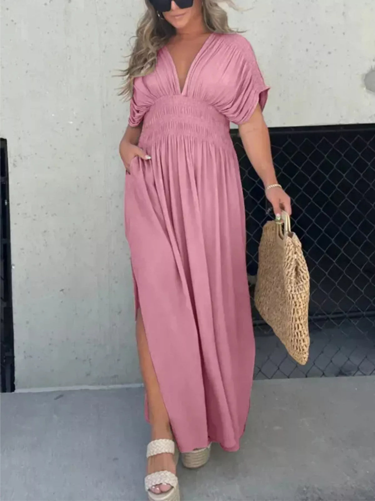 Plus size full slit V-neck maxi dress with smocked waist by Plush Fashion Hub, showing the flowing fabric and elegant design.