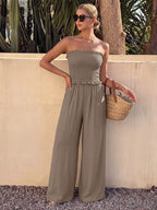 Smocked strapless wide-leg jumpsuit from Trendsi, featuring a relaxed fit and flowy fabric, perfect for casual and summer wear.