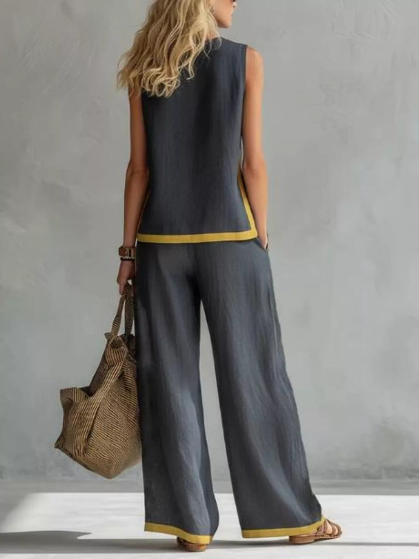 Plus size sleeveless top and wide-leg pants set with contrast stripe design by Trendsi, featuring a stylish, coordinated fashion ensemble.