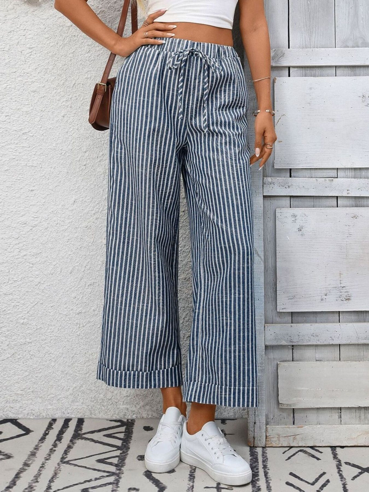 Women’s striped wide-leg drawstring pants with pockets by Plush Fashion Hub, shown in a relaxed fit with a comfortable waistband.