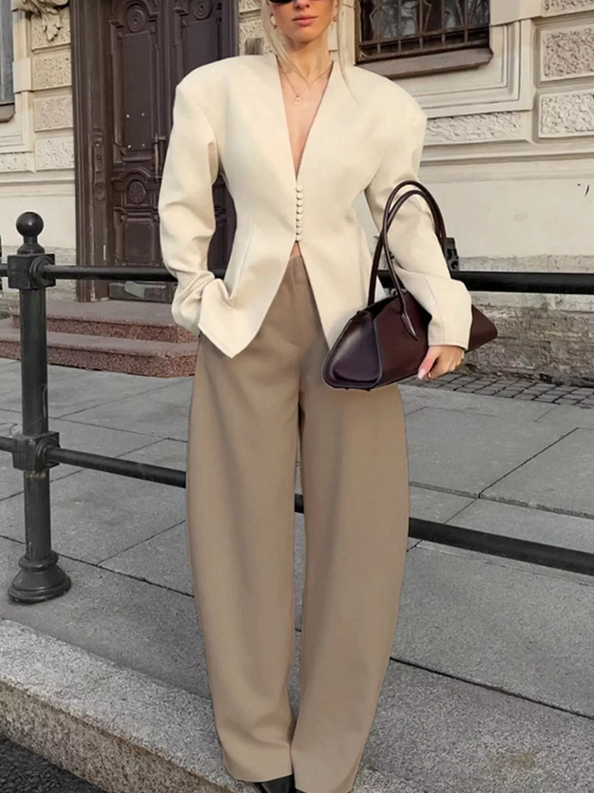 Trendsi women's V-neck button-up blazer with structured shoulders, tailored fit, and classic style, shown on a model.