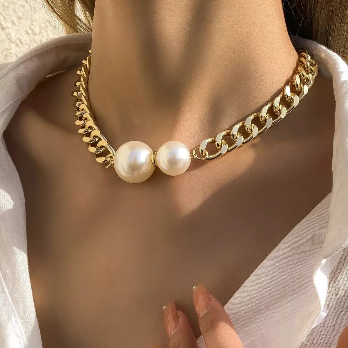 Elegant 18K gold-plated pearl necklace with a delicate chain and lustrous pearls, showcasing luxurious jewelry style.