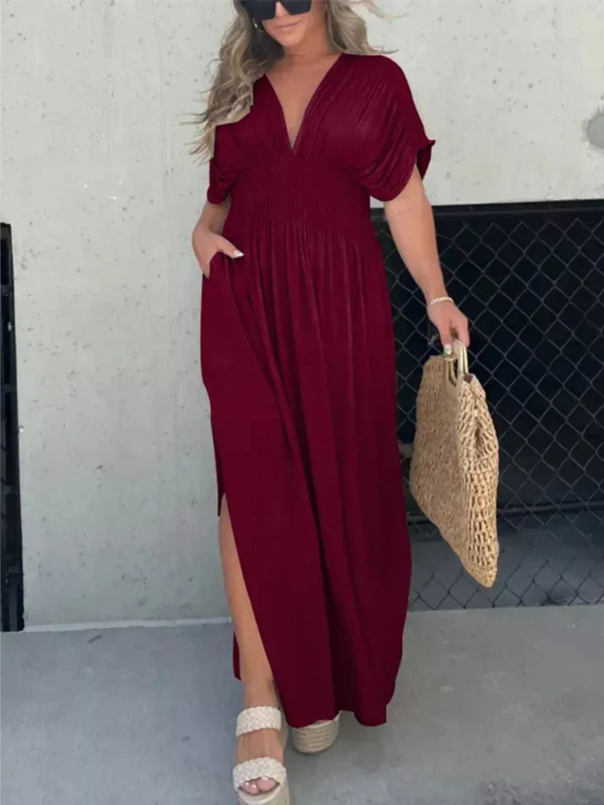 Plus size full slit V-neck smocked waist maxi dress by Plush Fashion Hub, featuring flowing fabric and a flattering silhouette.
