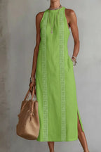 Women's sleeveless side slit maxi dress with pockets by Trendsi, featuring a flowy fabric and elegant design.