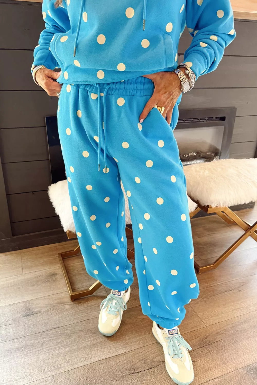 Plus size polka dot hooded drawstring long sleeve top and pants set by Trendsi, featuring a comfortable matching loungewear outfit.
