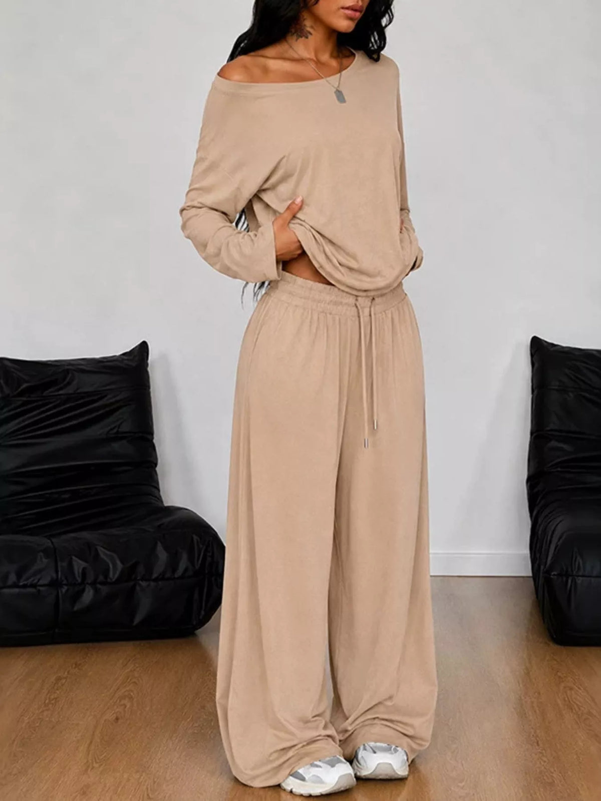 Plus size one-shoulder top and drawstring pants set from Trendsi, featuring a stylish matching outfit in vibrant fabric.