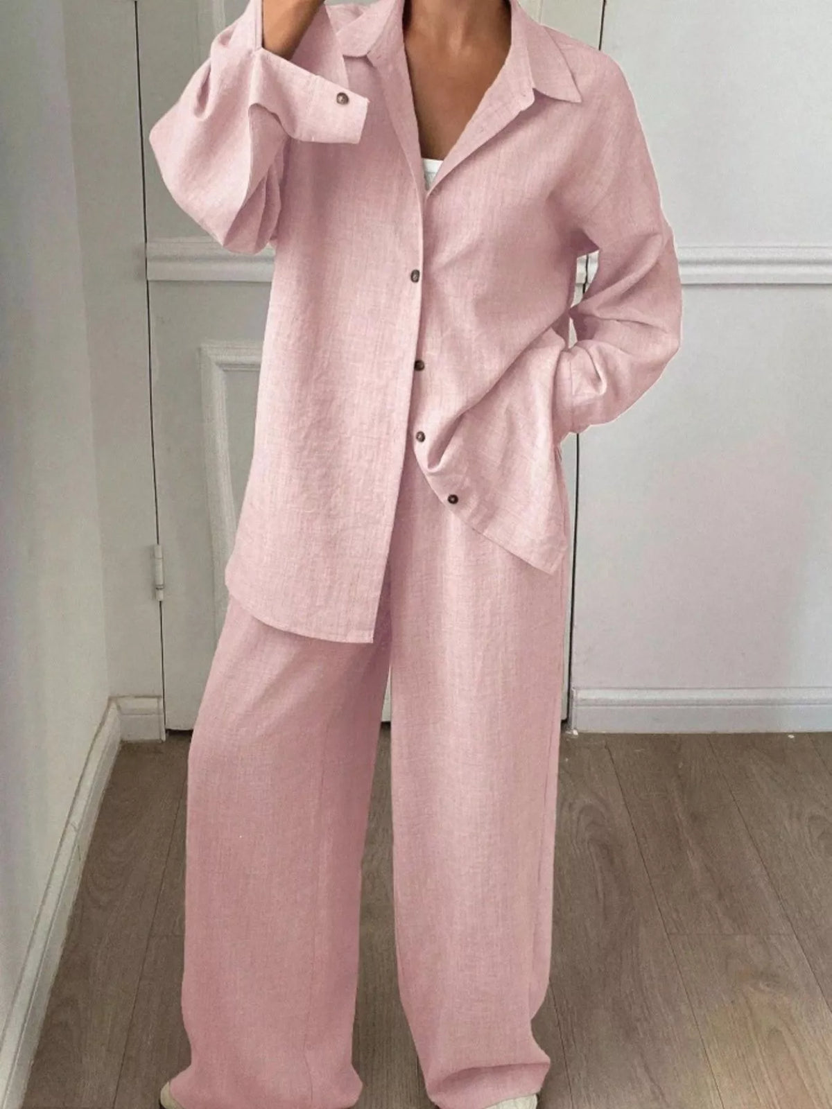 Trendsi long sleeve button-up shirt and wide-leg pants set displayed on a model, showcasing stylish and comfortable outfit.