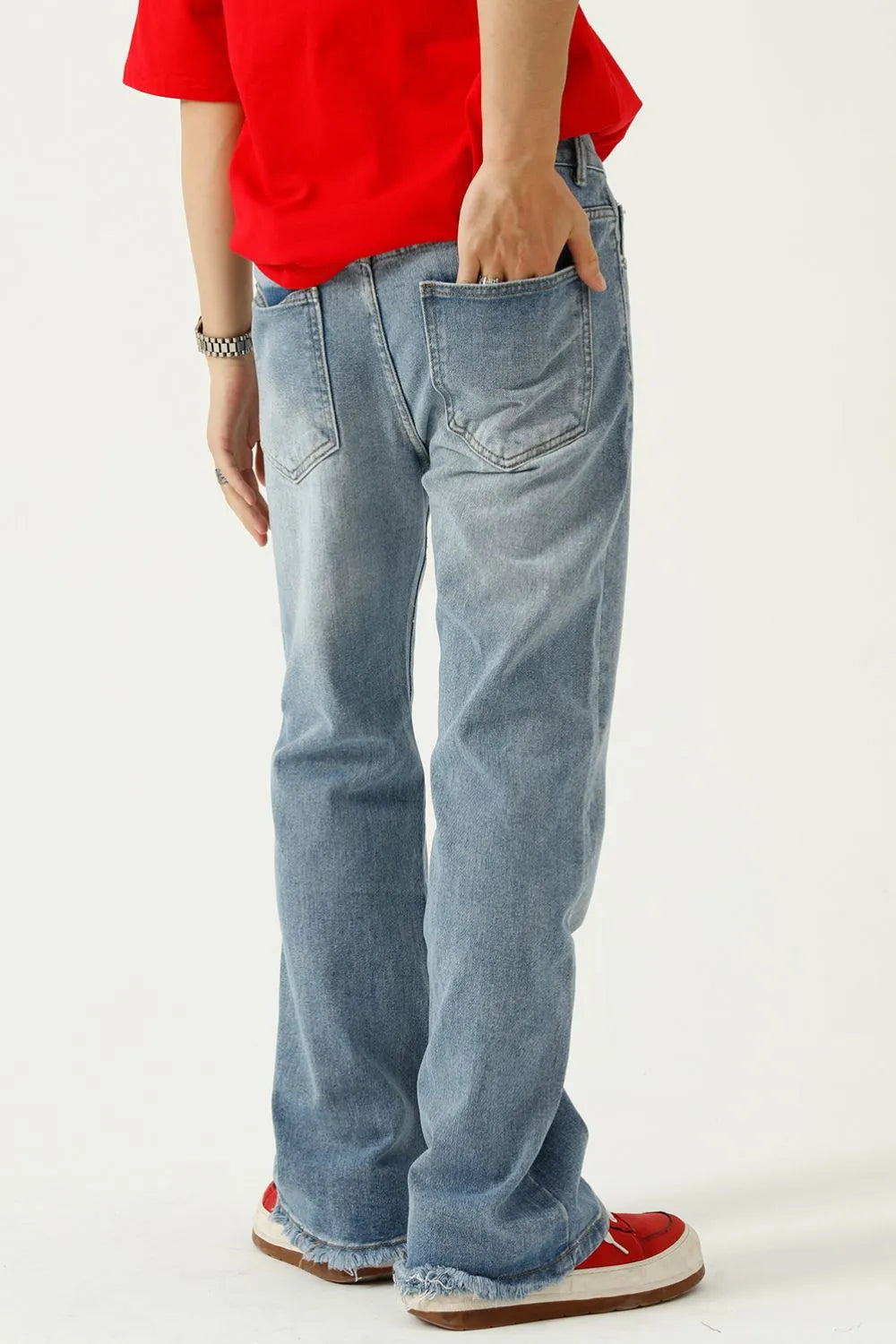 Raw hem denim jeans with pockets from Plush Fashion Hub, featuring a classic fit and distressed detail.